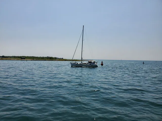 Sailboat cruising on calm blue water
