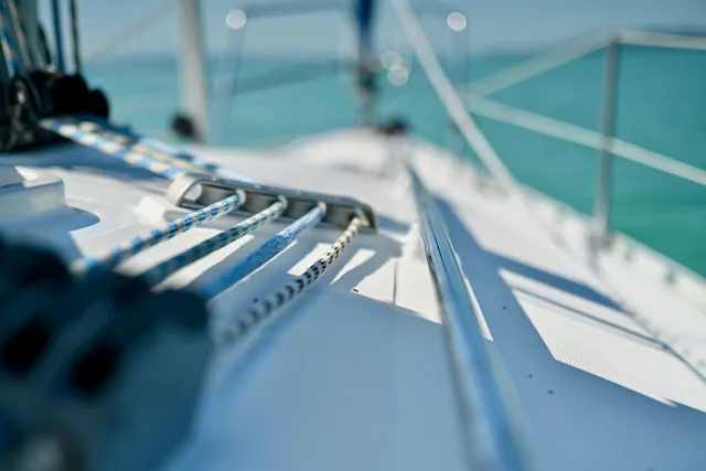 Blue and white sailing ropes running through deck hardware